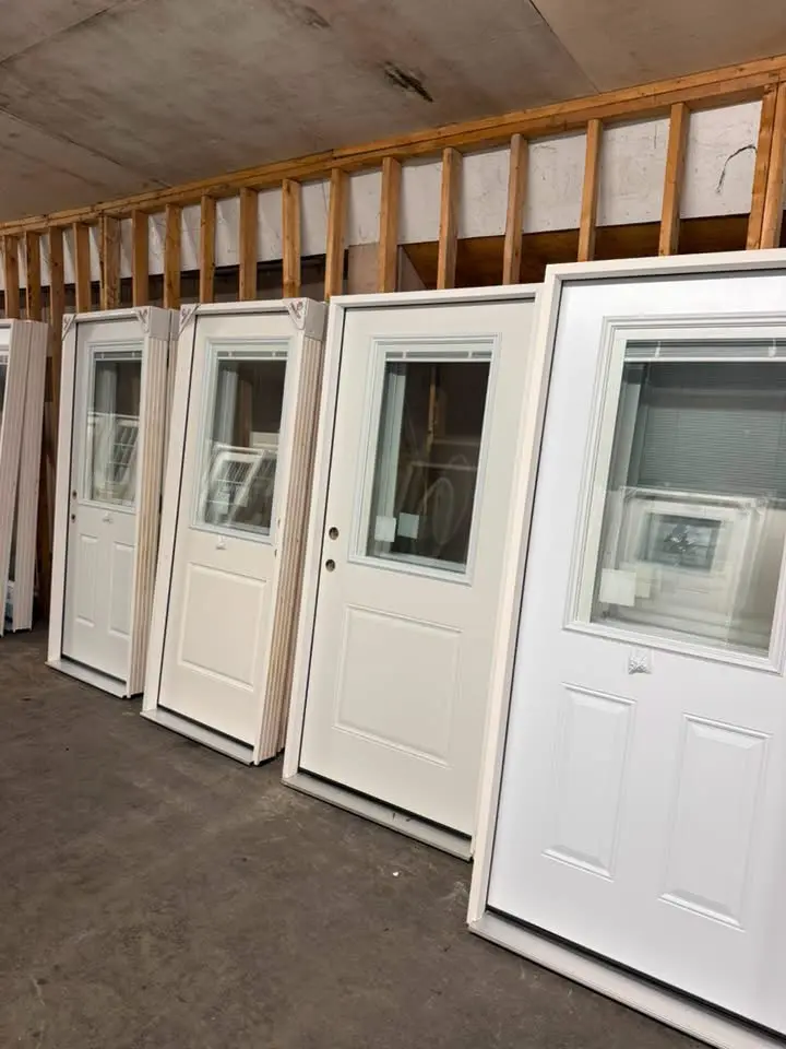 Multiple white entry doors available at the Brenton door warehouse