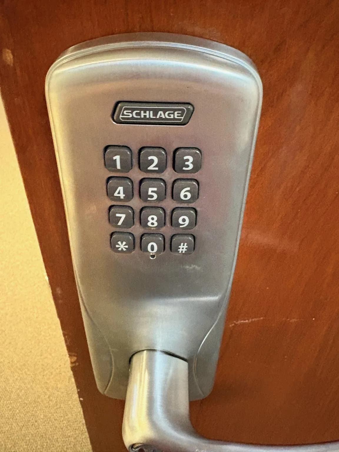 Electronic keypad smart lock mounted on a wooden door