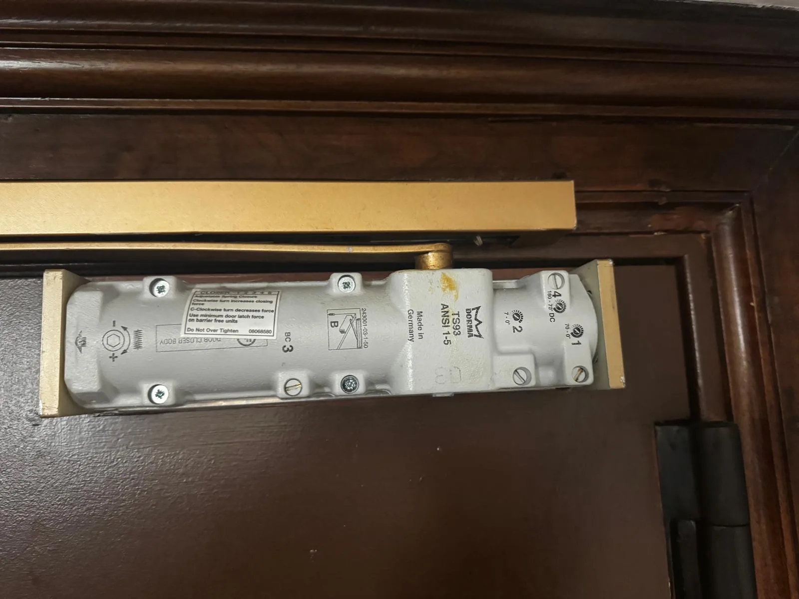 Overhead closer on wooden door