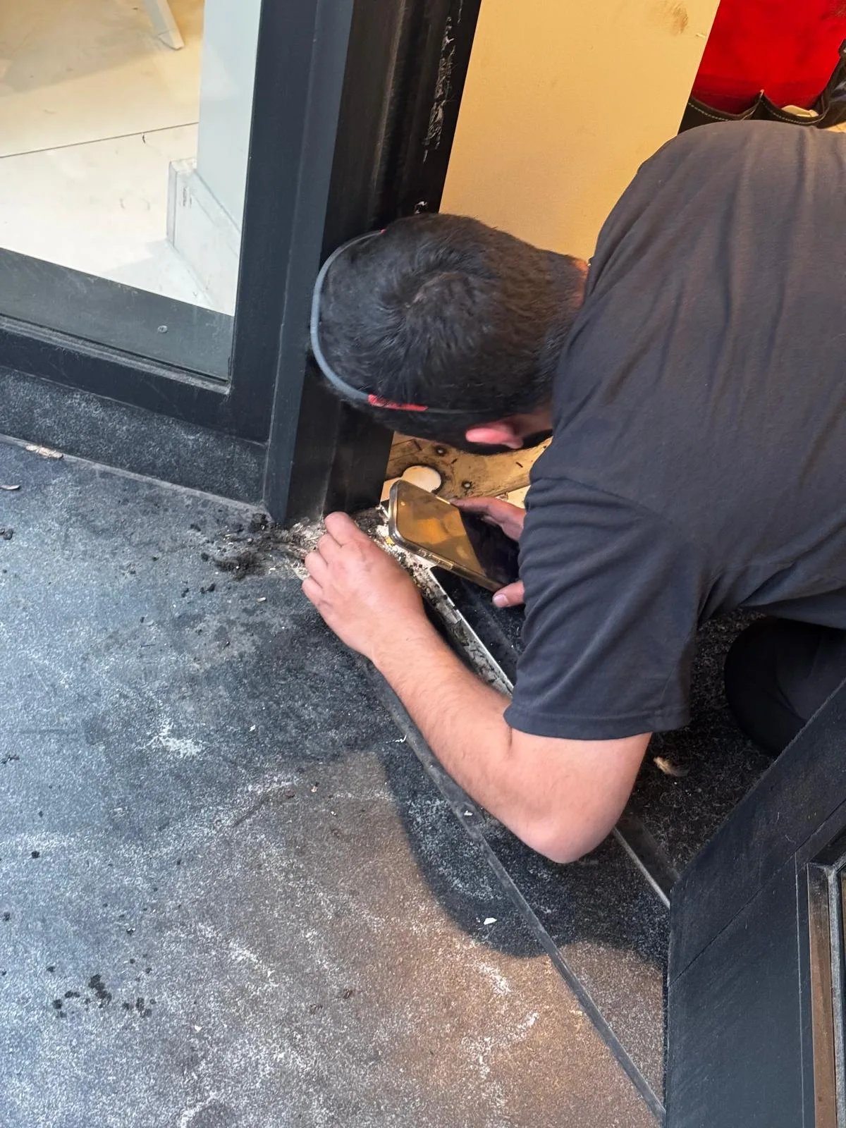 Technician replacing floor closer