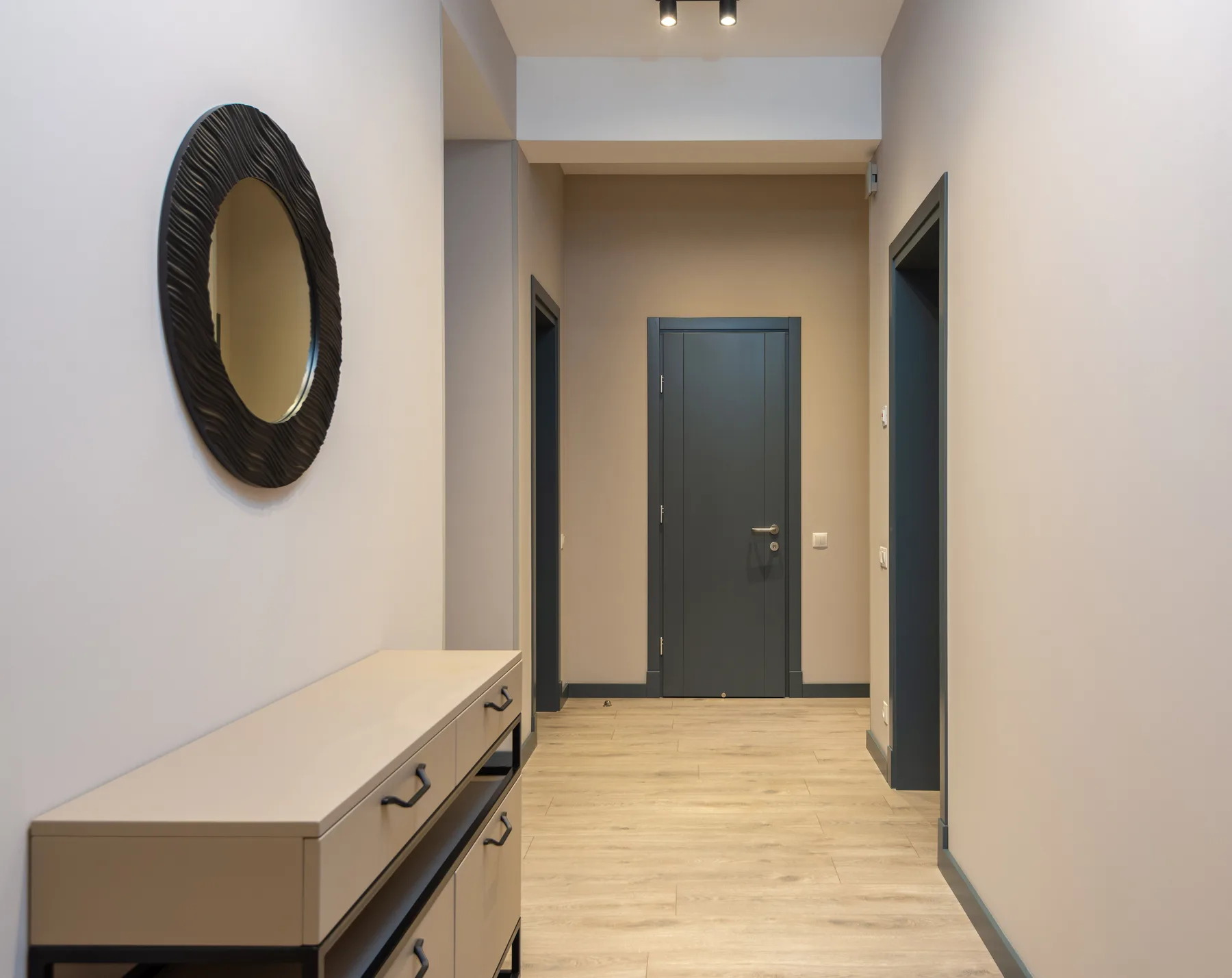 Minimal white hallway dark door