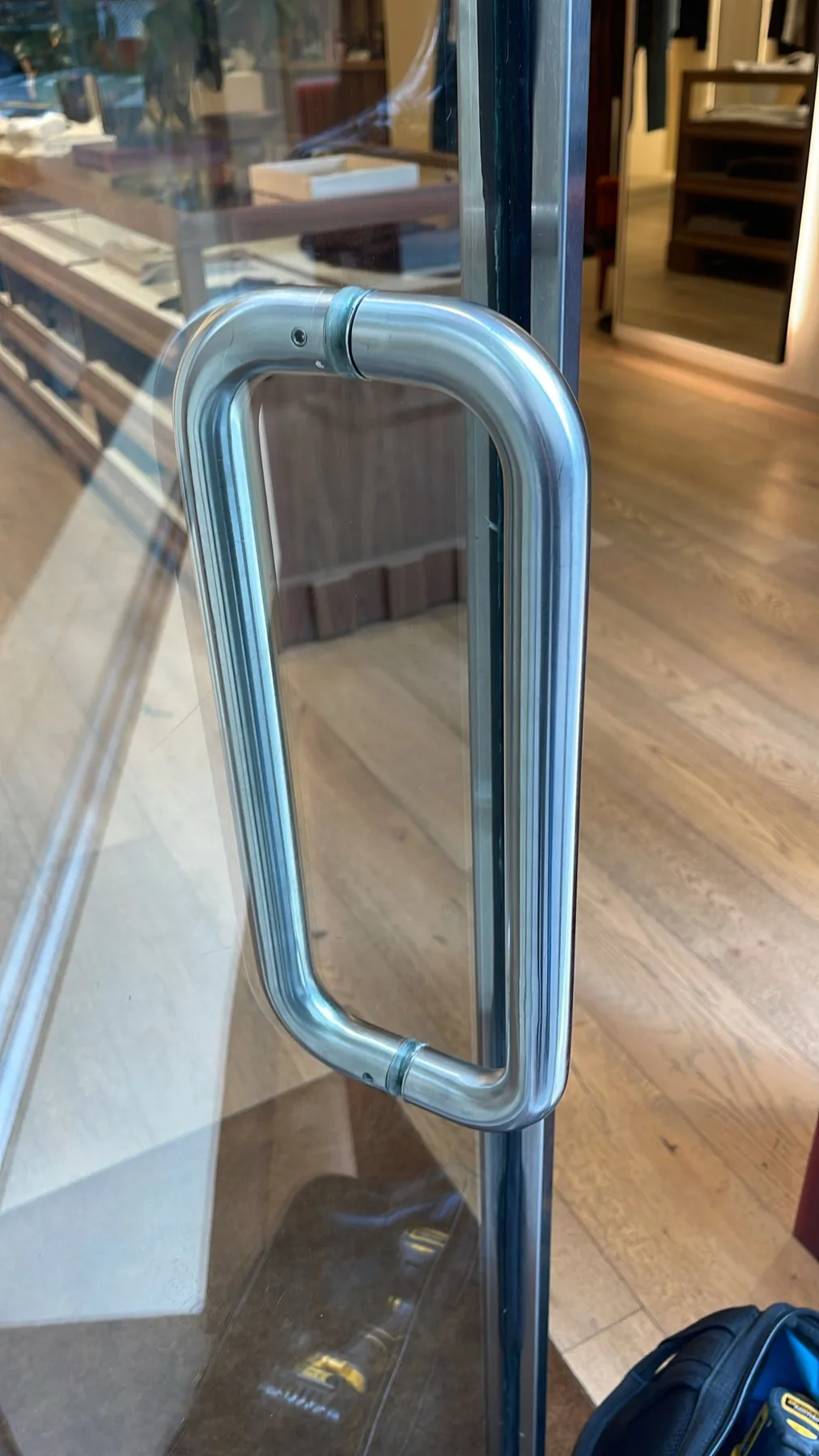 Glass door pull handle closeup